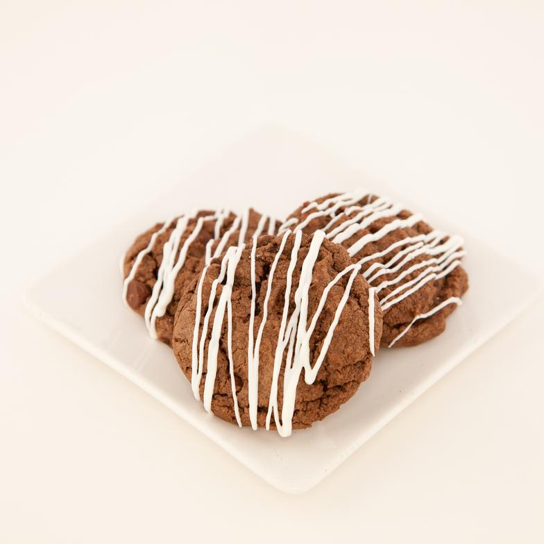 A delightfully rich chocolate cookie with chocolate chips and drizzled with white chocolate